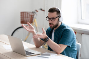 Man having an online meeting with his headphones